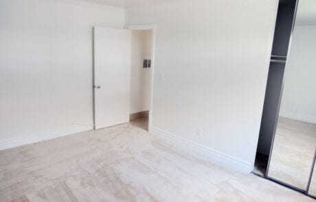 11-Unit1Bed1-2 Tustin Apartments - Las Casas Apartments - Spacious Bedroom With Cozy Carpet, and Mirror Sliding Door Closet