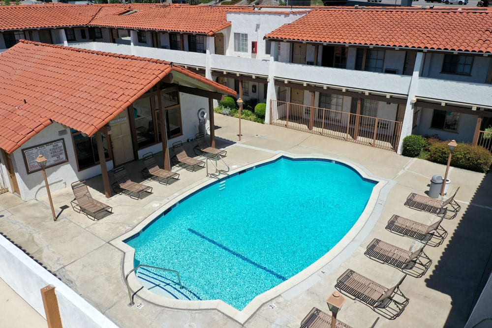 Apartments in Tustin, CA - Arial View of Las Casas Sparkling Swimming Pool Surrounded By Lounge Seating