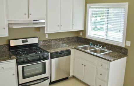 Tustin CA Apartments - Las Casas Apartments -Spacious Kitchen With Granite Countertops, White Cabinets, and Stainless Steel Appliances