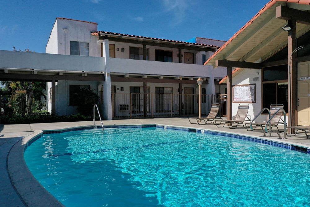 default Apartments for Rent in Tustin - Las Casas Apartments -Sparkling Swimming Pool Surrounded by Lounge Chairs